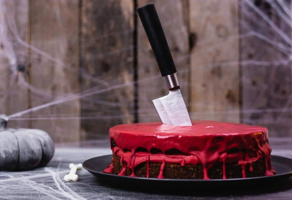 Ein blutiger Halloween Kuchen mit einem Messer.