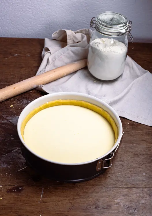 In die Backform mit dem Mürbeteig wird die Käsekuchenmasse des Käsekuchen Rezeptes gefüllt.