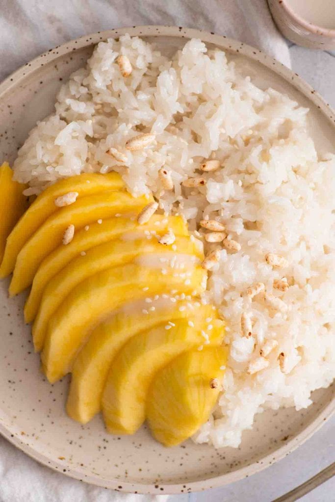 Die Mangos, der Klebereis, die Kokossauce und die Mungbohnen in der Nahaufnahme.