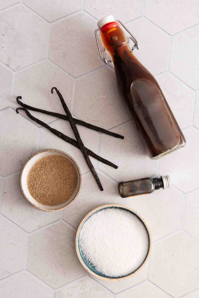 Vanilleextrakt, Vanillezucker, Vanilleschoten, Vanillepaste auf dem Tisch.